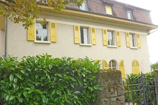 Fenêtres à petits carreaux encadrées de volets jaunes